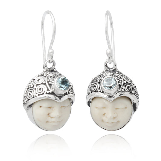 Pendientes de plata con cara tallada en hueso y topacio